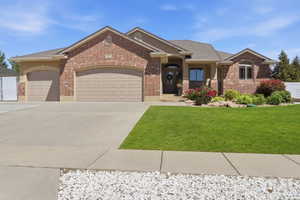 Brick and stucco exterior featuring multiple gables, an arched entry, and a covered porch