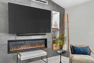 Feature wall with stone-look paneling, integrated linear fireplace, and recessed shelving