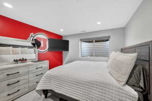Bedroom featuring recessed lighting, a window with horizontal blinds, and carpeted flooring