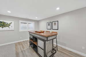 Industrial-style island with a wood-finish countertop, corrugated metal accents, and integrated shelving