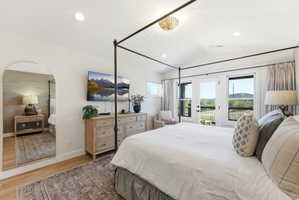 Vaulted ceiling room with recessed lighting and a decorative chandelier