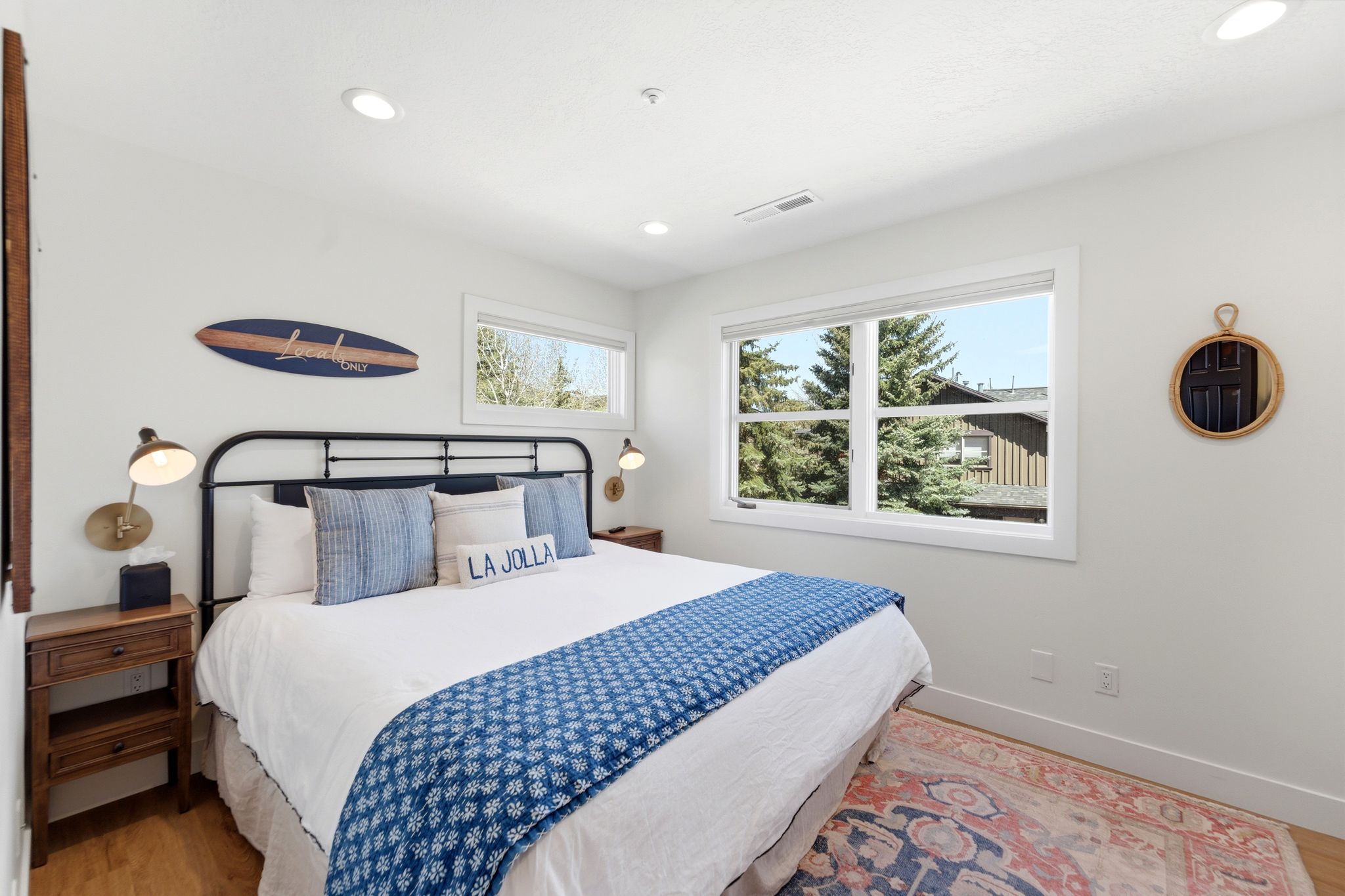 Bright room featuring white walls, recessed lighting, and wood-finish flooring