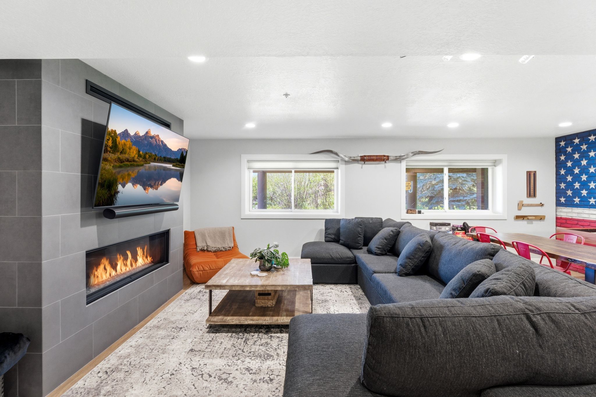 Living area featuring a floor-to-ceiling tiled fireplace surround with an integrated linear fireplace