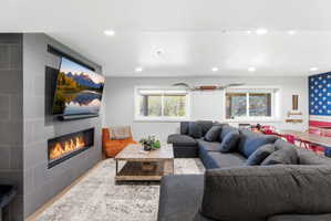 Living area featuring a floor-to-ceiling tiled fireplace surround with an integrated linear fireplace