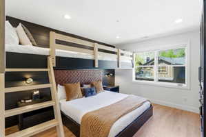 Bedroom featuring built-in bunk beds with natural wood framing
