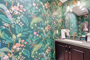 Vibrant botanical wallpaper with peacock accents