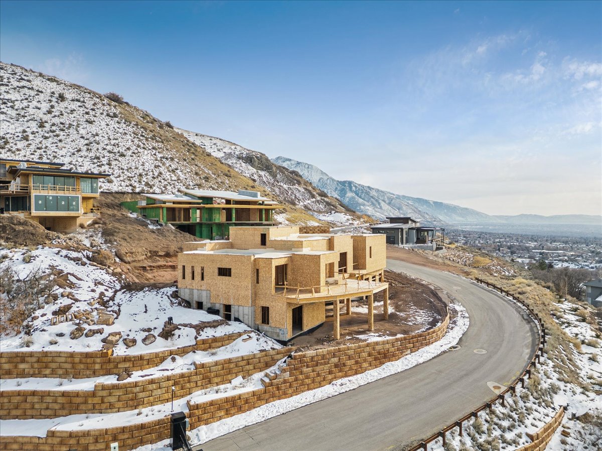 Modern architectural structure under construction, featuring multiple levels and an expansive outdoor deck