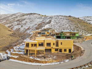 Modern architectural design featuring multi-level construction and expansive window openings
