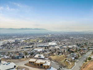 Expansive aerial perspective showcasing a broad urban landscape with distant mountains