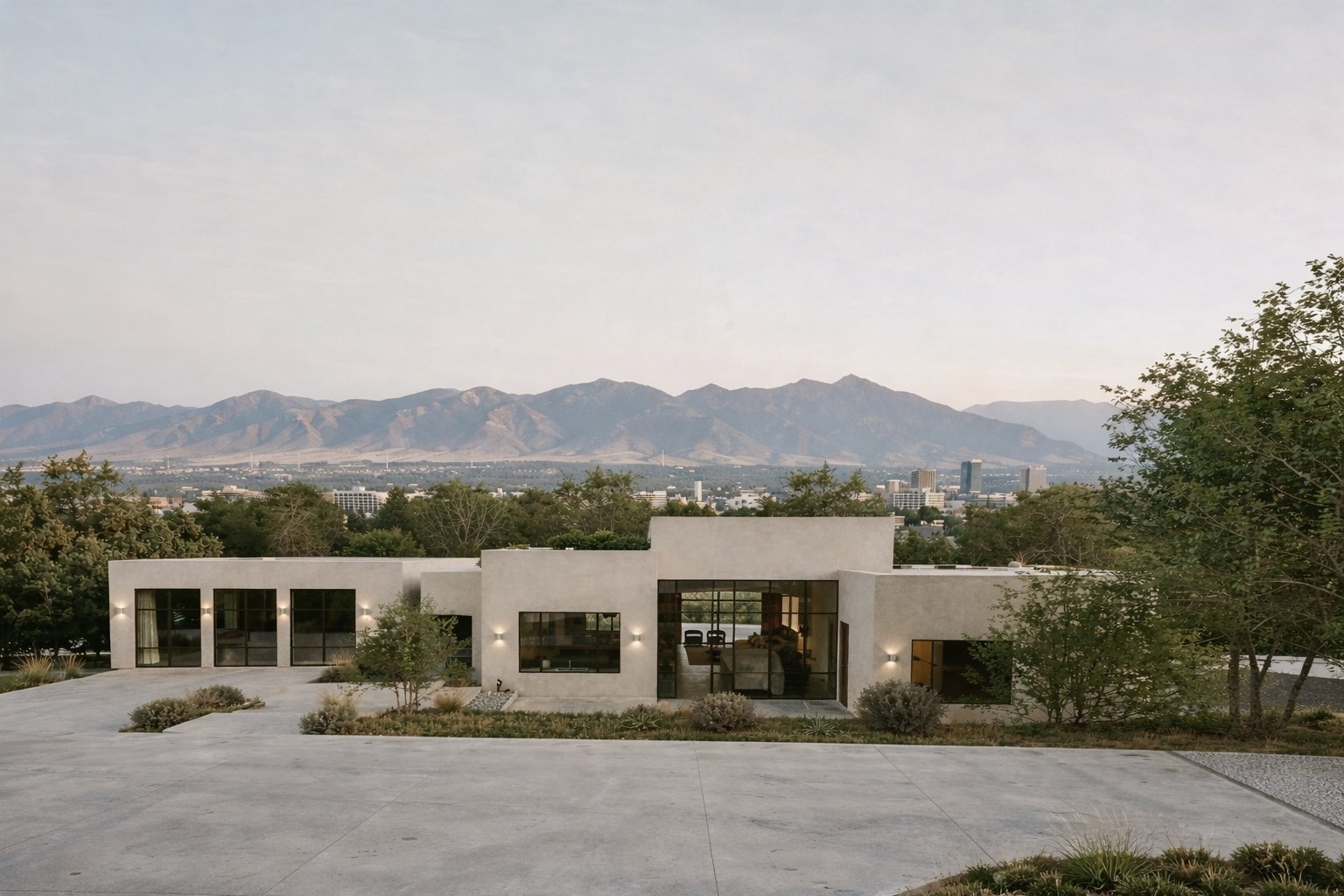 Modern architecture with expansive windows, a flat roofline, and integrated outdoor lighting