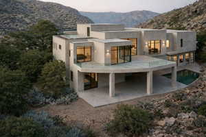 Modern multi-level residence featuring a stucco exterior and expansive window placement