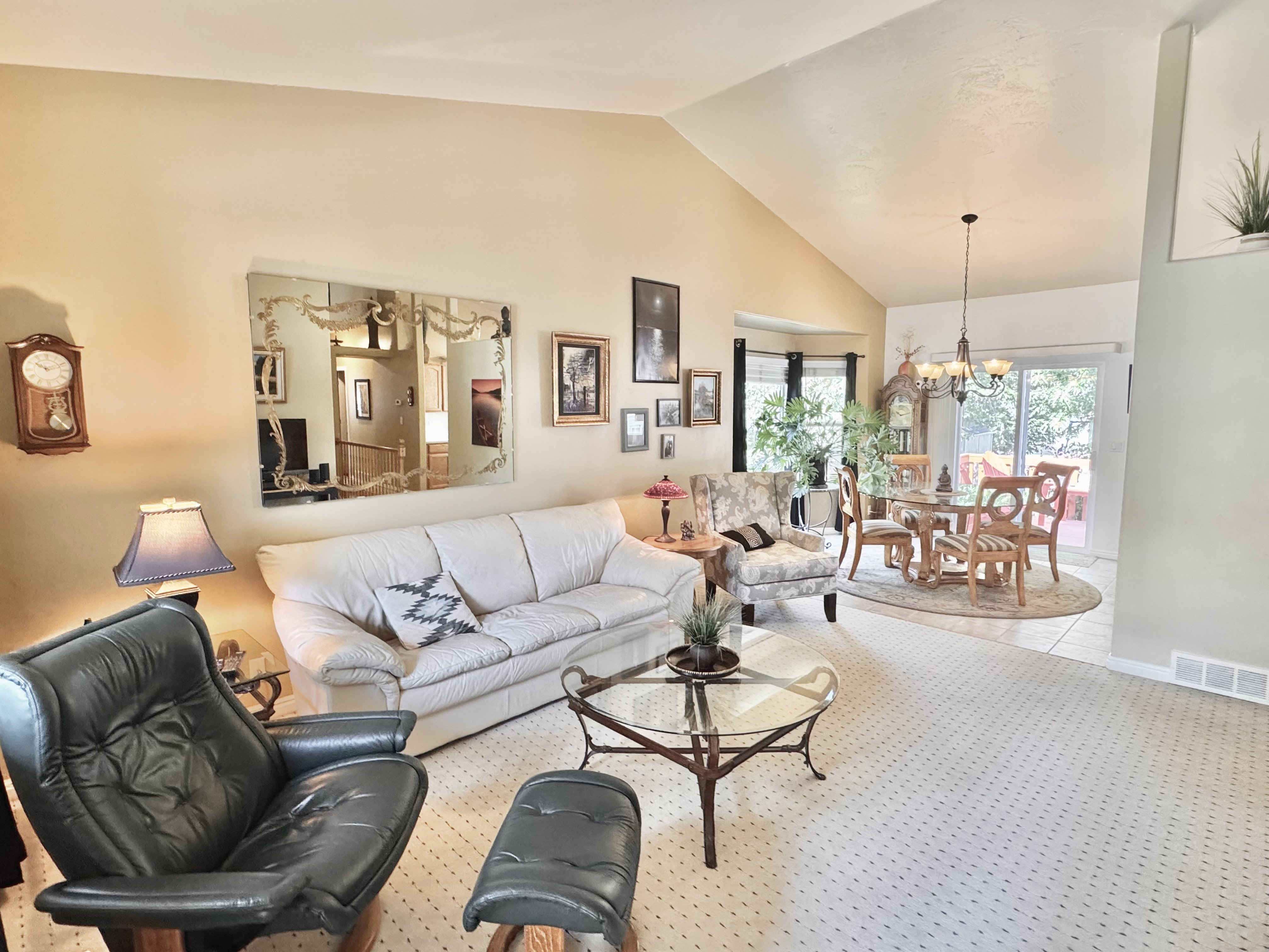 Open living room and dining area with sliding doors leading to the deck