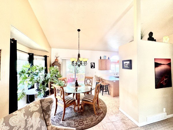 Dining area with tiled flooring and a bay window
