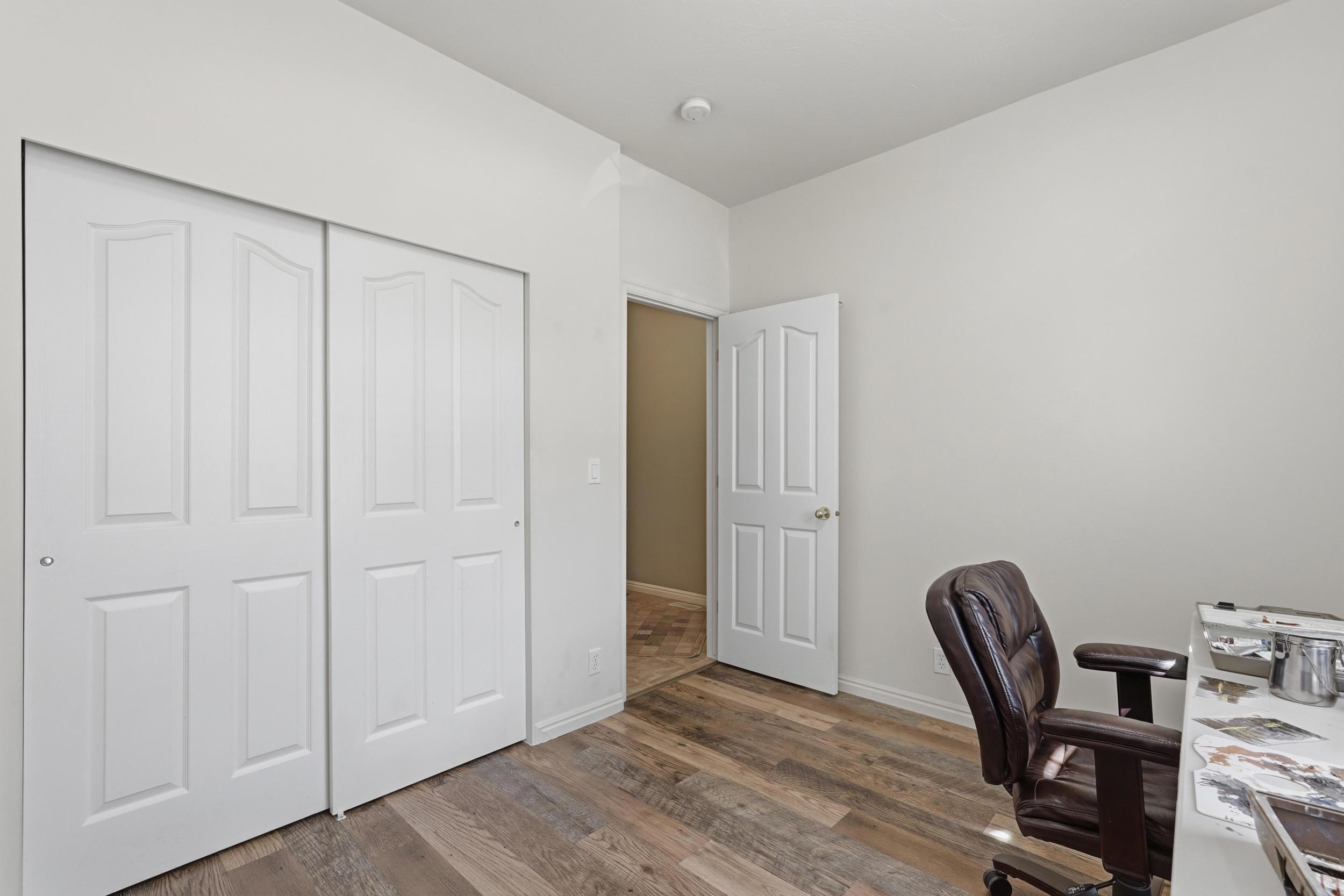 Second bedroom featuring LVP flooring and a closet
