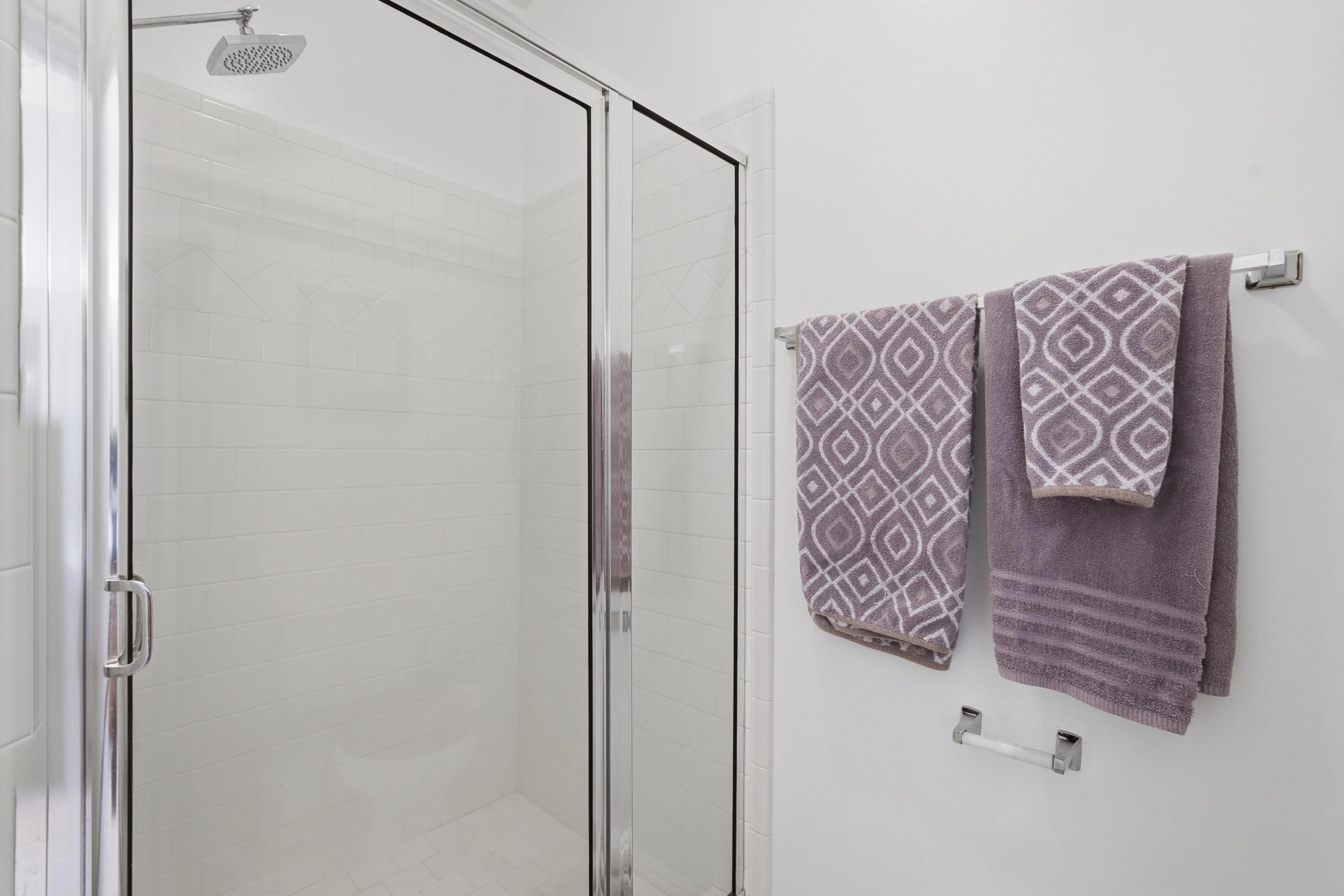 Separate en suite walk-in shower and toilet behind closed door.
