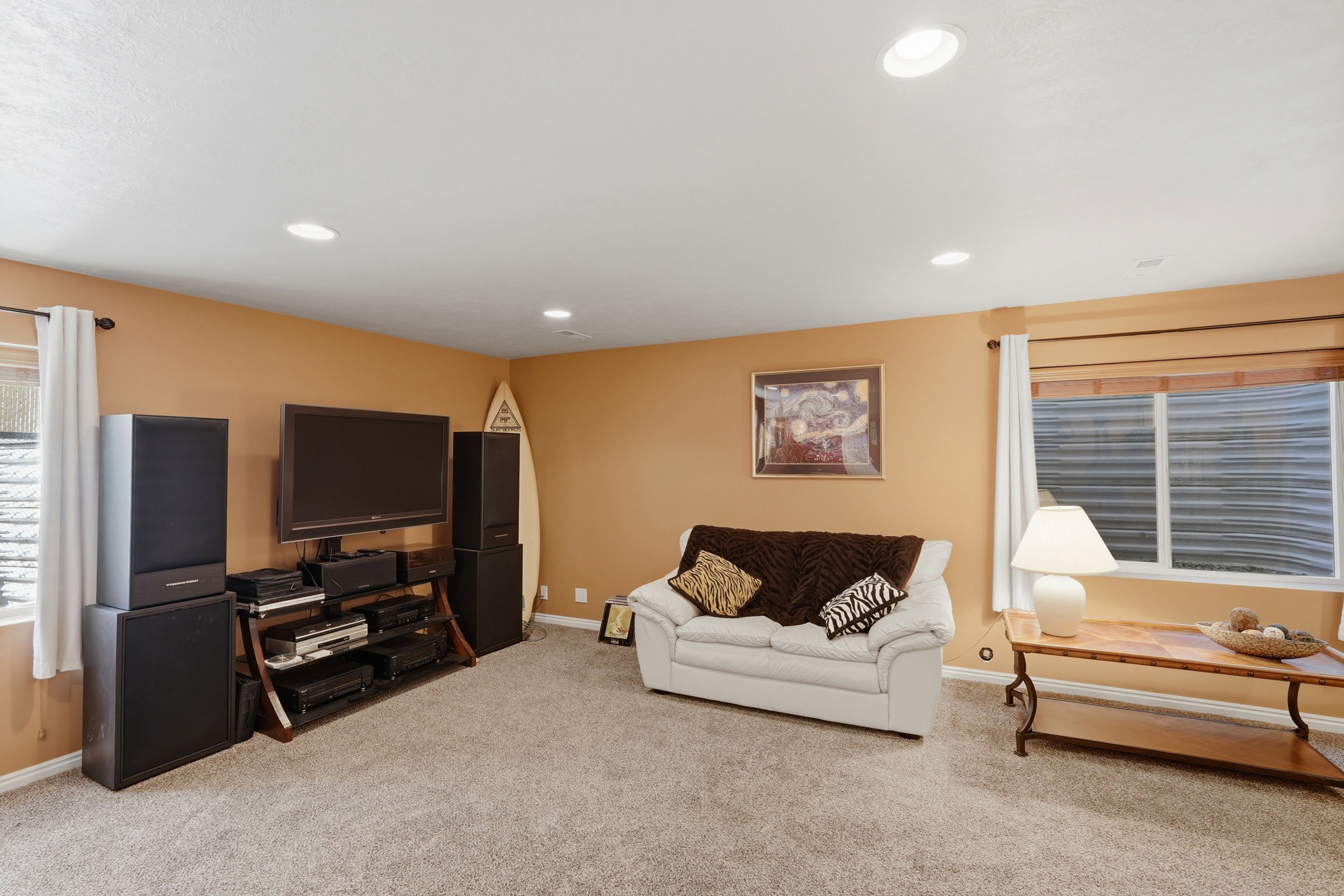Carpeted room featuring recessed lighting and two windows
