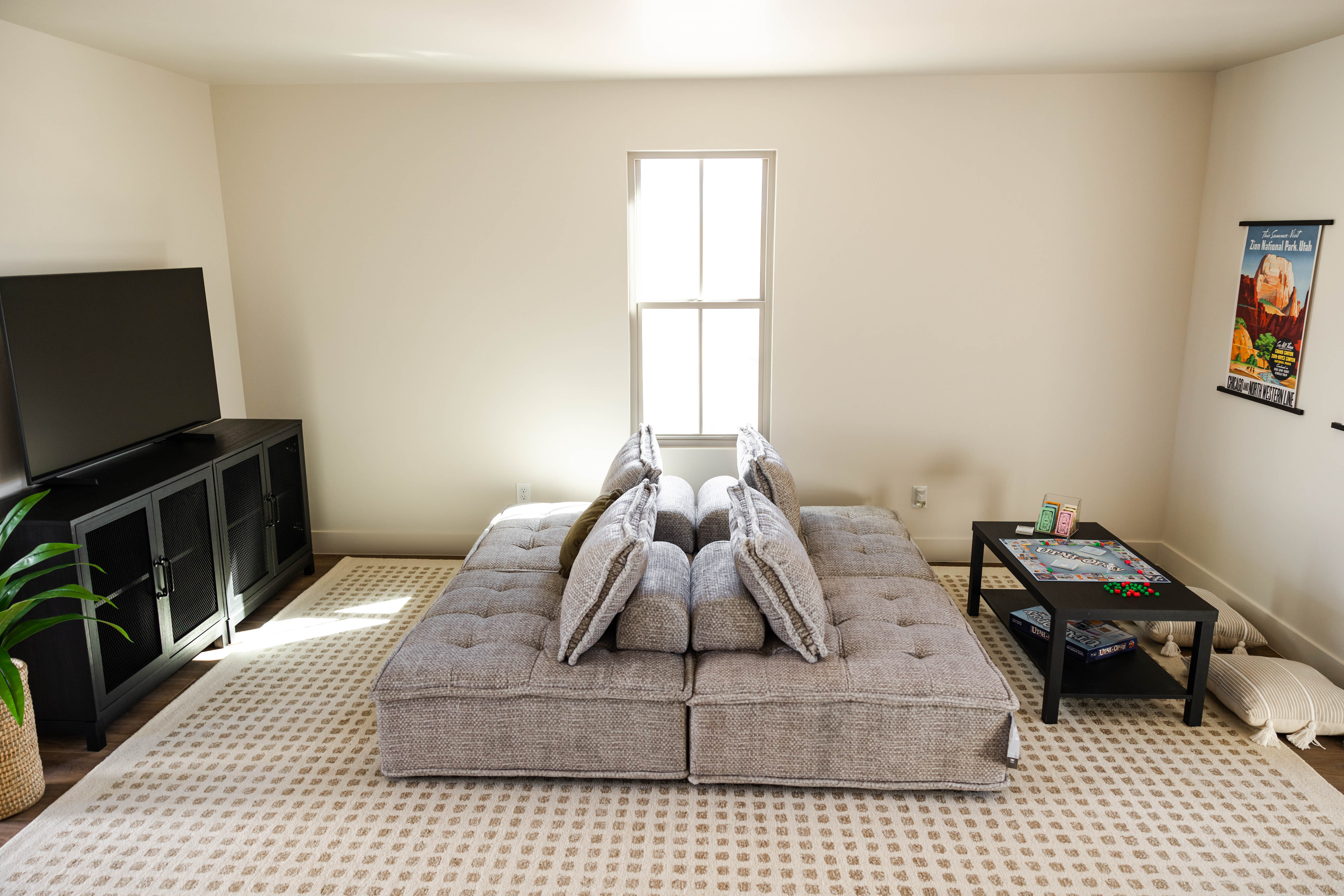 Bright interior space with a double-hung window, light-colored walls, and wood-finish flooring