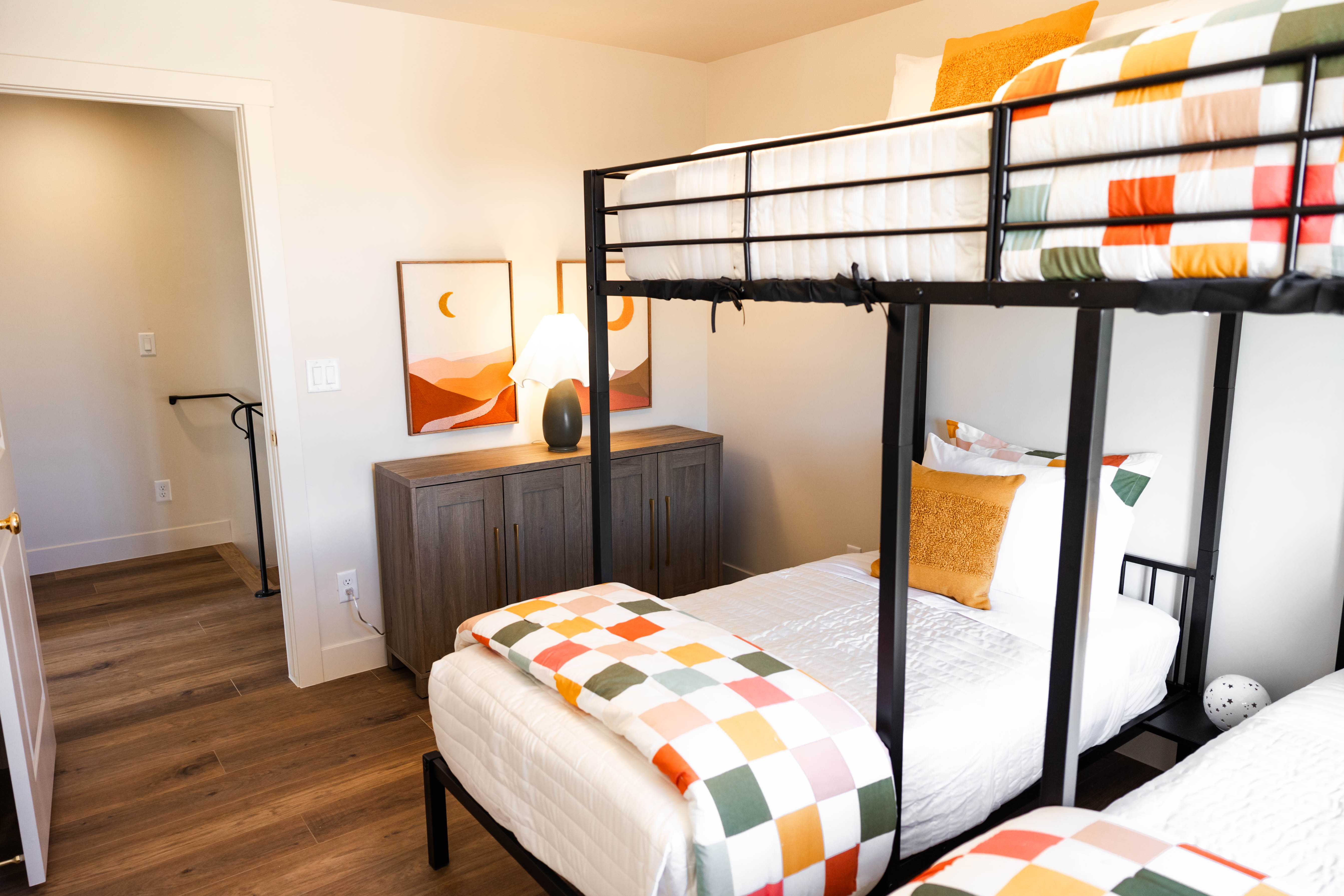 Room featuring wood-finish flooring, white baseboards, and light-toned walls