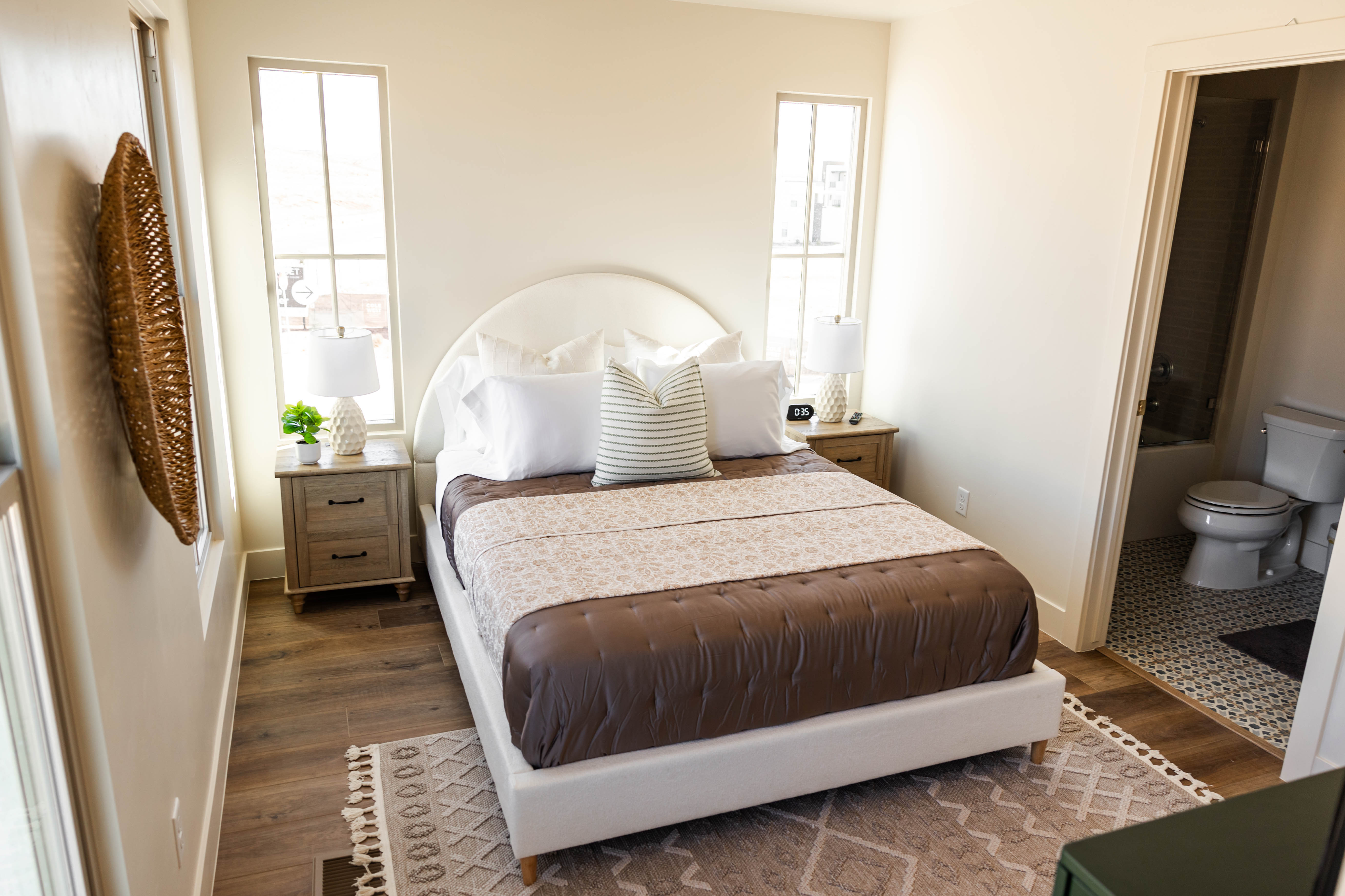 Bedroom with wood-finish flooring and light-toned walls