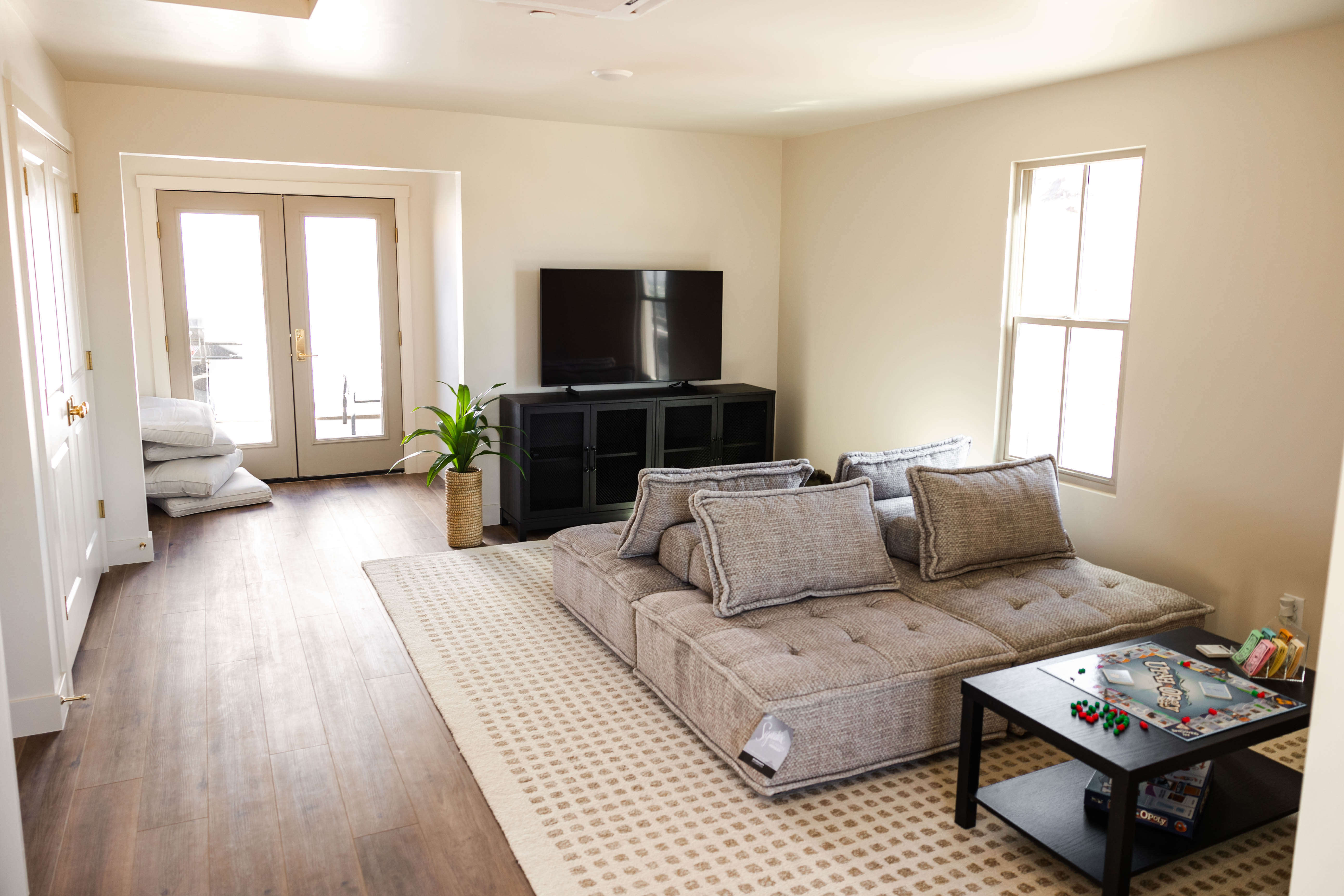 Living space with wood-finish flooring, light-toned walls, and a recessed ceiling light