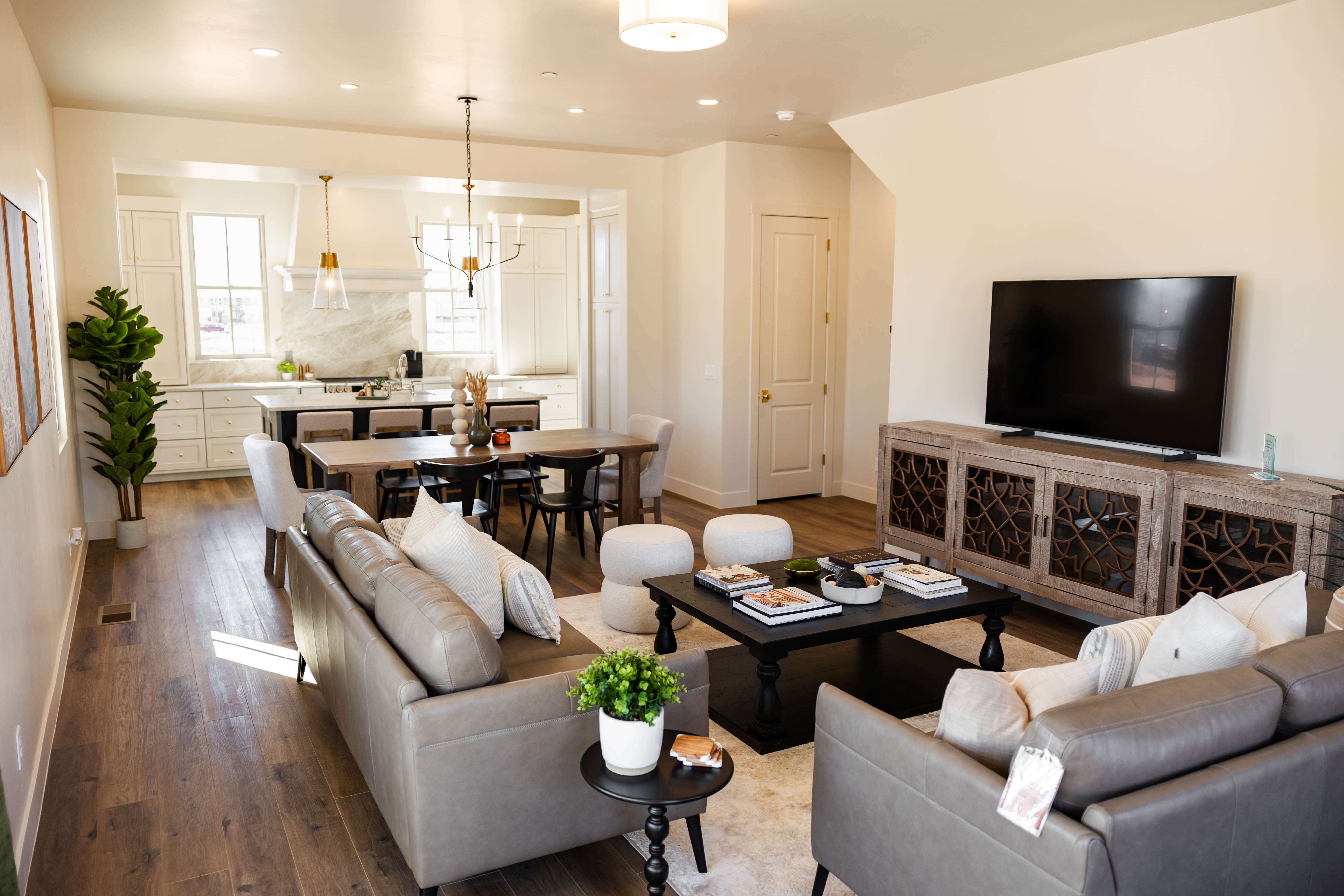 Open-concept living space featuring wood-finish flooring, recessed lighting, and white walls