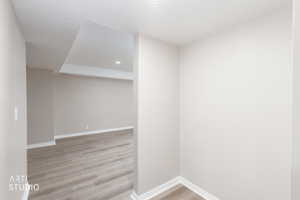 Open interior space featuring light wood-finish flooring, recessed lighting, and crisp white trim