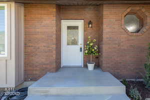 Brick facade with a white front door featuring a decorative glass insert