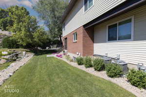 Manicured lawn with a gravel border and retaining rock wall