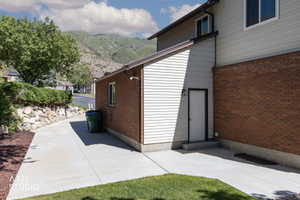 Exterior features brick and horizontal siding, with a concrete driveway leading to a rear entry