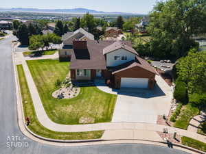 Two-story residence featuring a brown shingle roof and a two-car garage