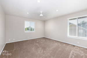 Spacious room featuring neutral carpeting and light-toned walls
