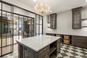 Central island with a light-toned countertop, accompanied by dark wood-finish cabinetry