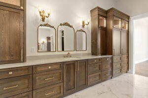 Extensive built-in cabinetry with wood-finish doors and brass hardware