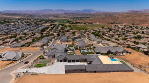 Expansive property featuring a large swimming pool, two tennis courts, and a substantial paved driveway
