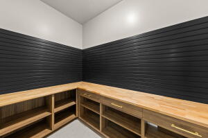 Built-in wood-finish shelving and countertops provide ample storage