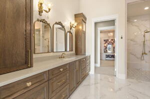 Spacious bathroom featuring an extended wood-finish vanity with ample storage