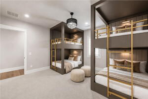 Room featuring two built-in bunk bed structures with integrated lighting, a ceiling-mounted chandelier, recessed lighting, and light-toned carpet flooring