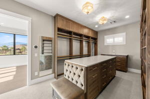 Custom built-in wood cabinetry and shelving define this organized closet space