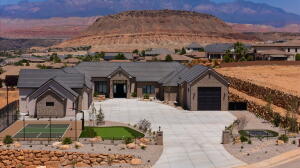 Contemporary ranch-style residence featuring a paved driveway, integrated garage, and a separate detached garage structure