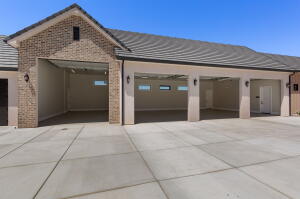 Multi-bay garage with extensive concrete driveway