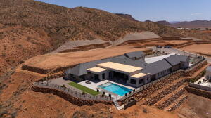 Contemporary residence featuring a private pool and surrounding paved patio