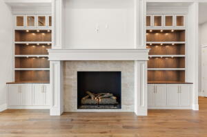 Gas fireplace with a stone surround and a substantial white mantelpiece