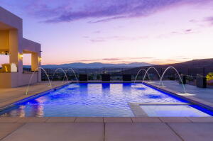 Resort-style pool with integrated fountains and underwater lighting