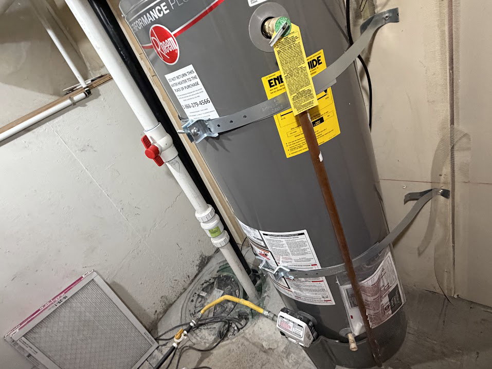 Water heater with securing straps and visible piping