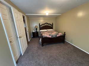 Carpeted interior room featuring neutral wall tones, white baseboards, and a semi-flush mount ceiling light