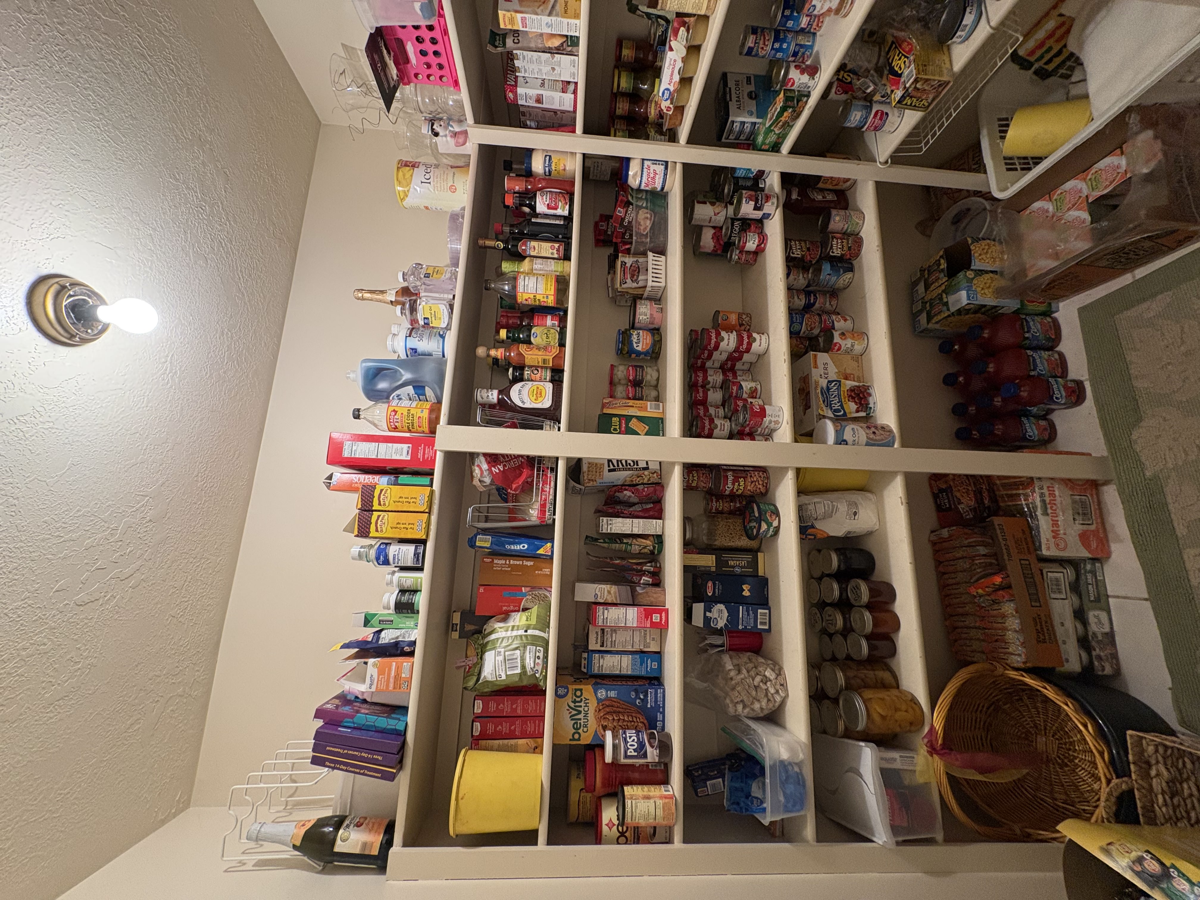 Spacious pantry featuring built-in shelving, ample storage capacity, and recessed ceiling lighting
