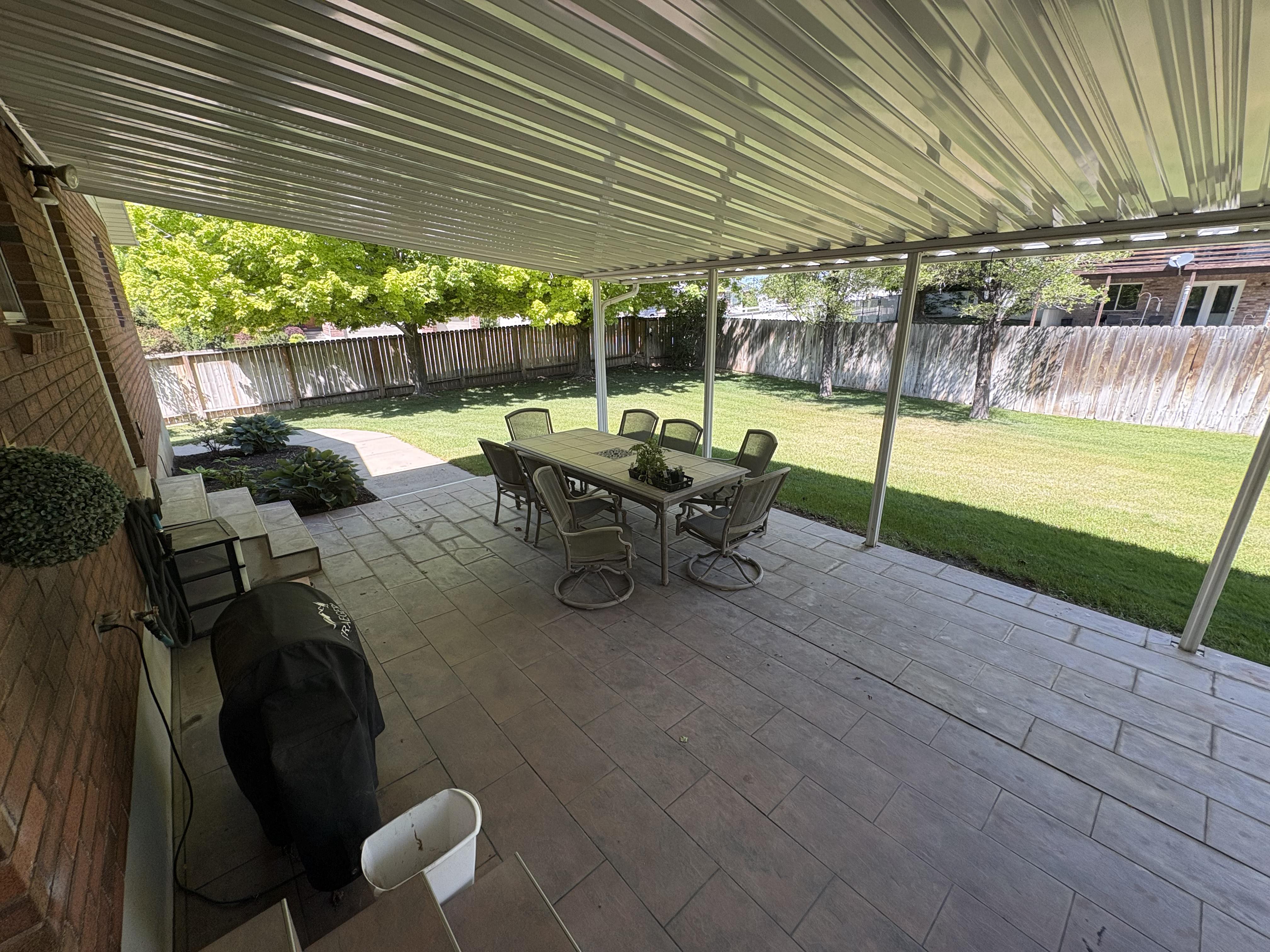 Covered patio featuring a corrugated metal roof and support columns