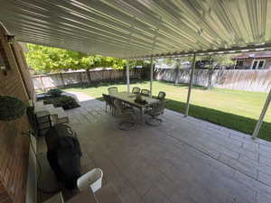 Covered patio featuring a corrugated metal roof and support columns