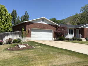 Red brick and white siding exterior with a two-car garage