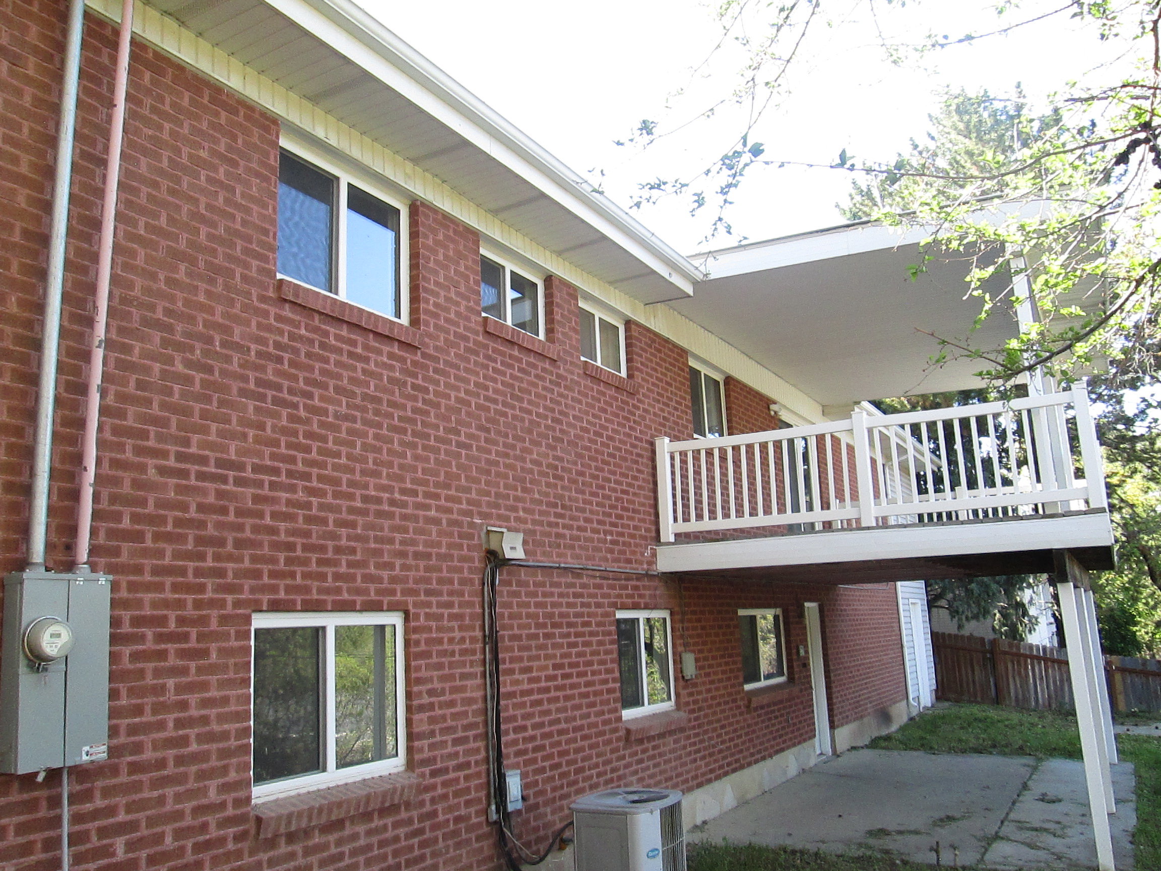 Red brick exterior with multiple windows